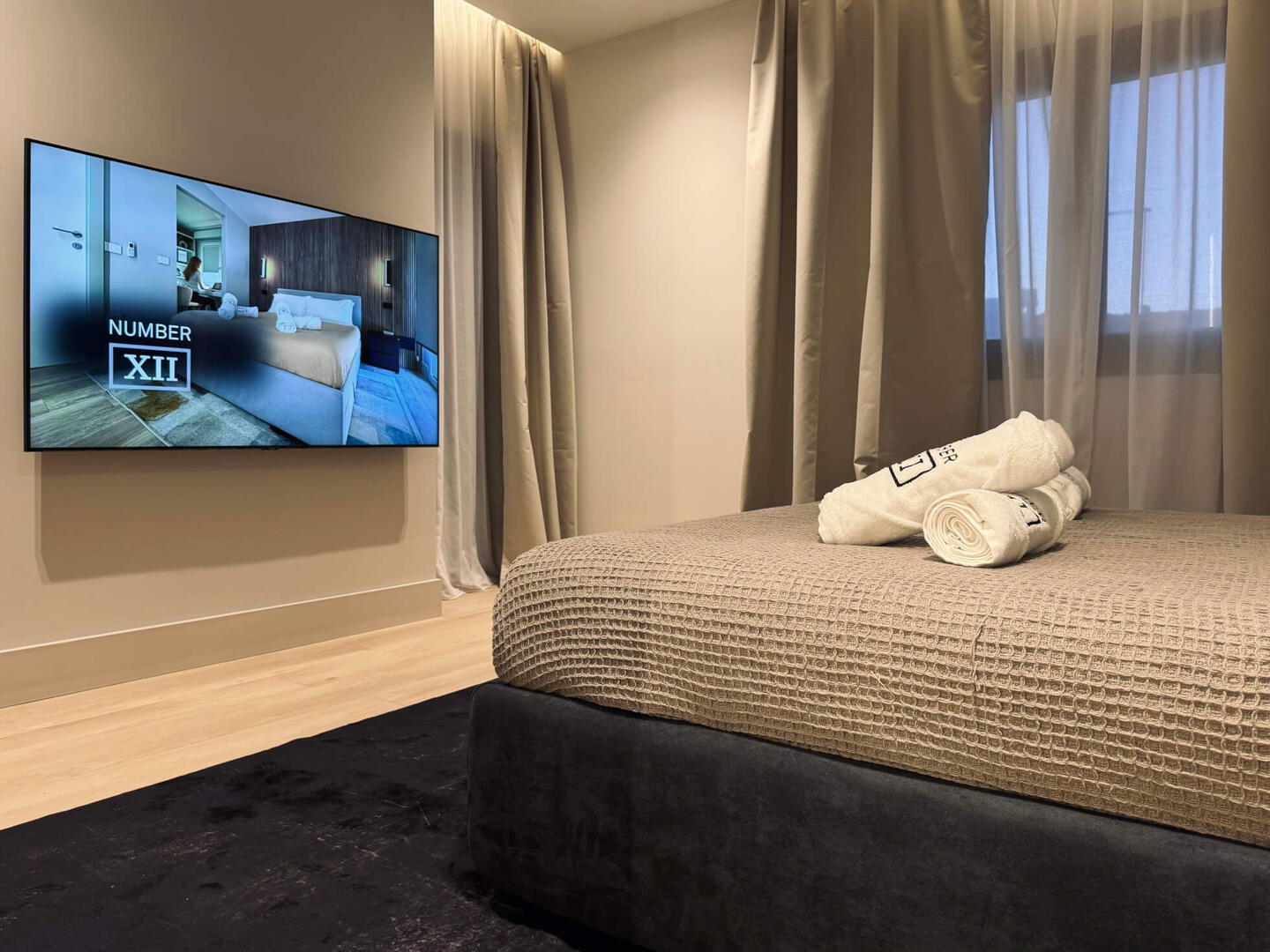 A quality king-size bed, custom-made premium pillows, and a large TV