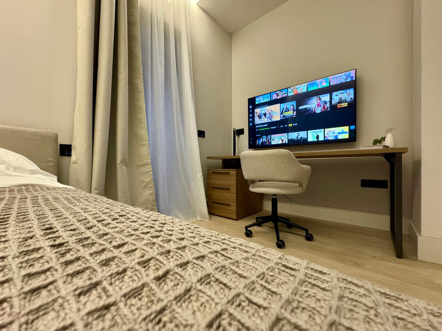 Second bedroom with 2 single beds (can convert to a double bed) and workspace.